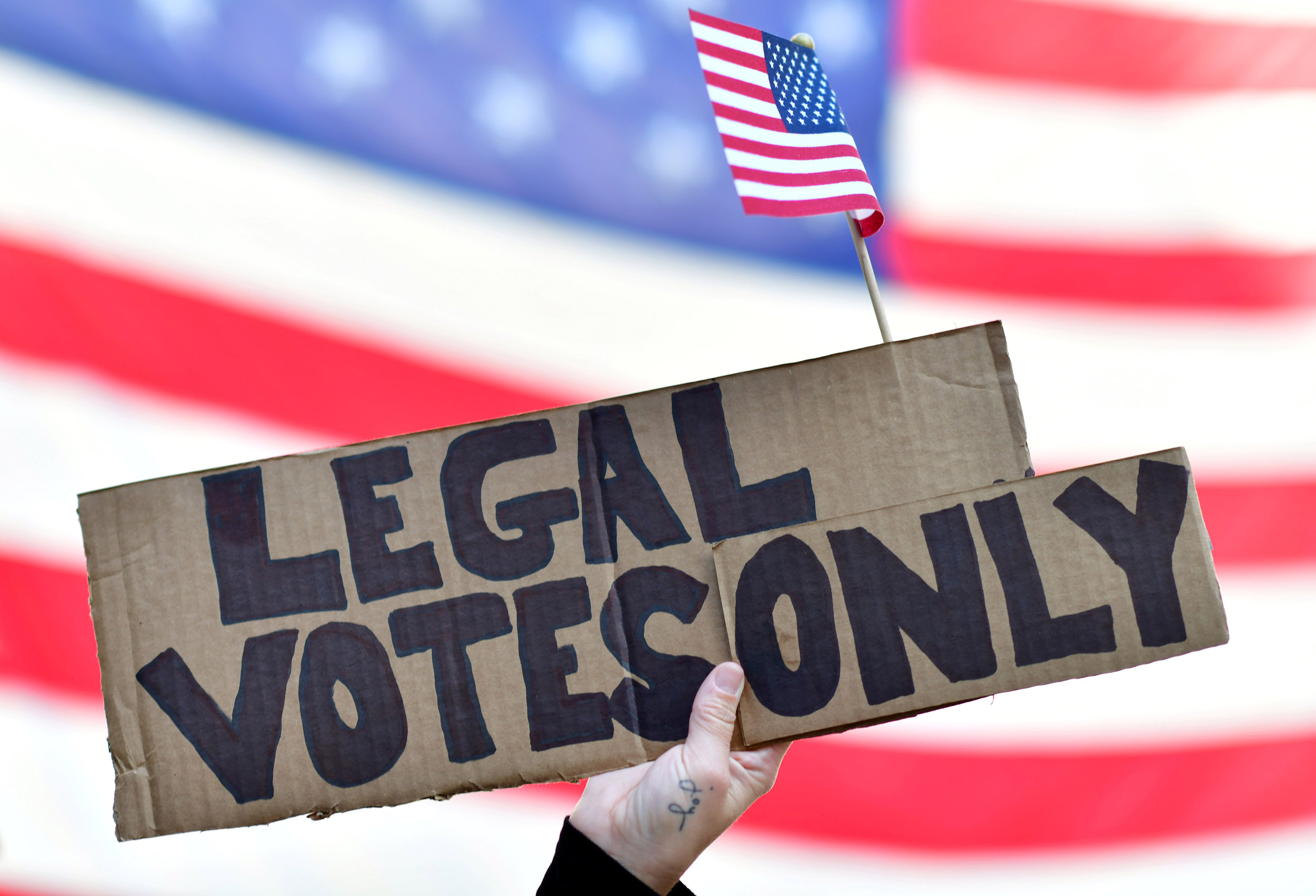 Image: Trump supporter Carri Dusza holds a placard reading “Legal votes only” outside where general election ballots continue to be tabulated, the day after a presidential election victory was called for former Vice President Joe Biden, in Philadelphia, P
